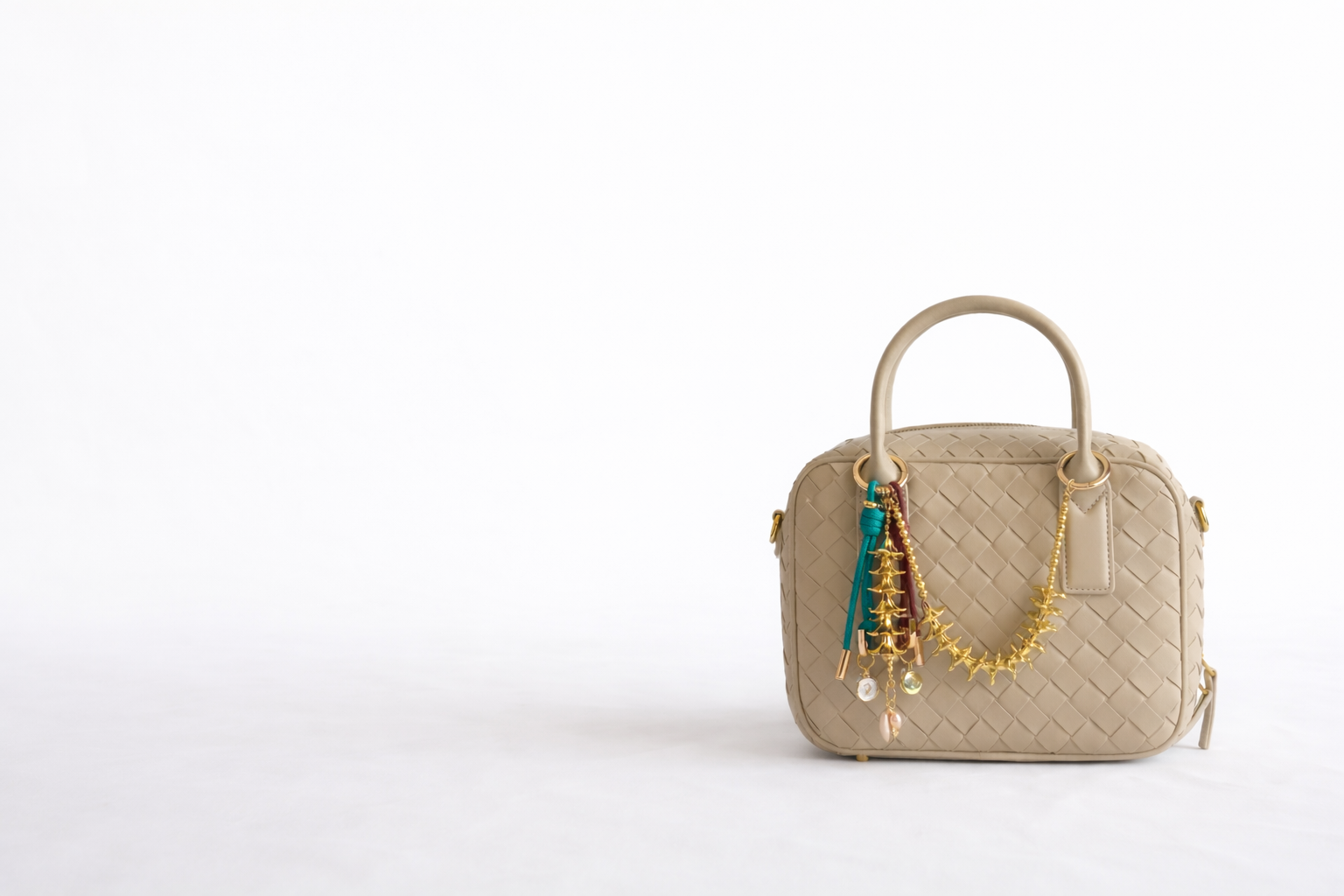 teal and brown bag charm with gold plumeria bag charm