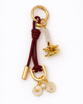 Keychain with gold and red elements on a white background