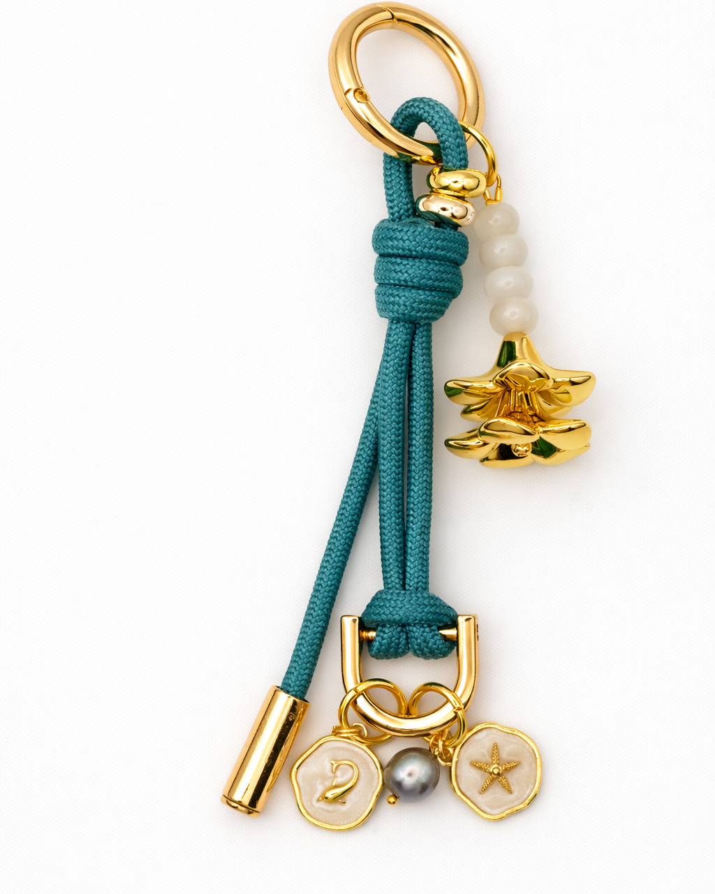 Teal and gold charm on a white background