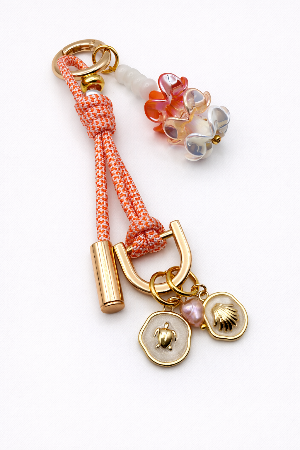 Handcrafted Leo bag charm in Puakenikeni with gold-tone hardware and sculptural translucent baubles